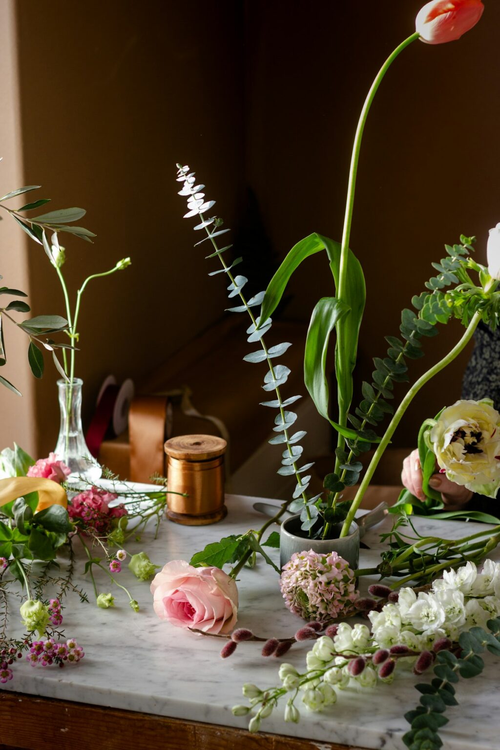 Florist workbench with stems, tools and ribbon in the studio