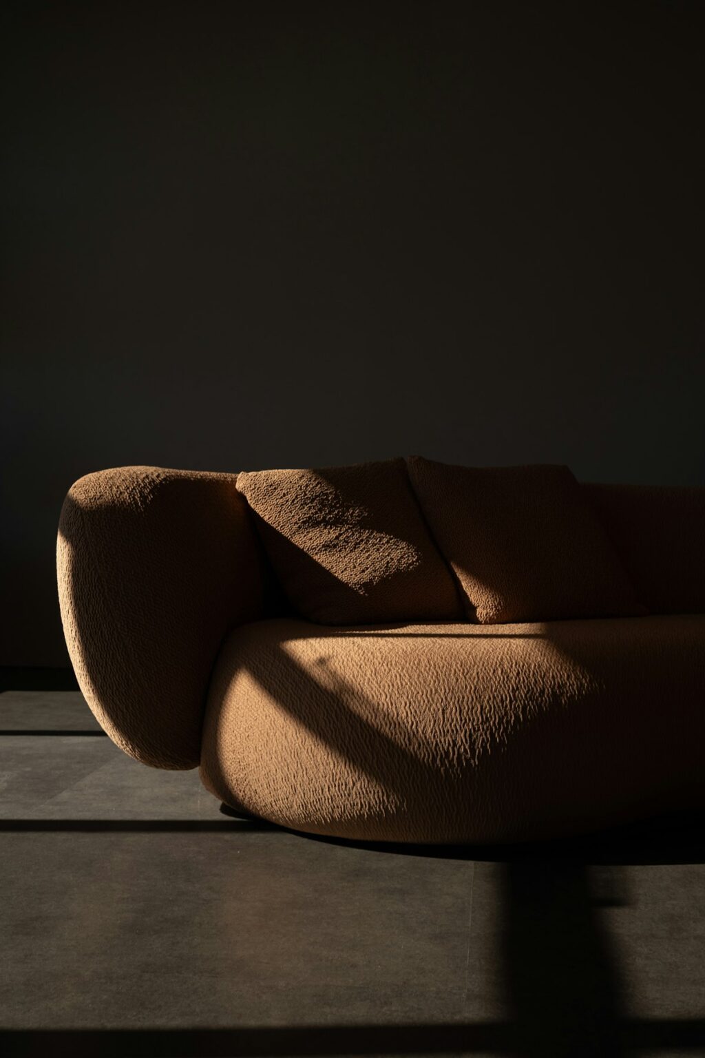 Styled interior corner with a textured bouclé sofa in warm light