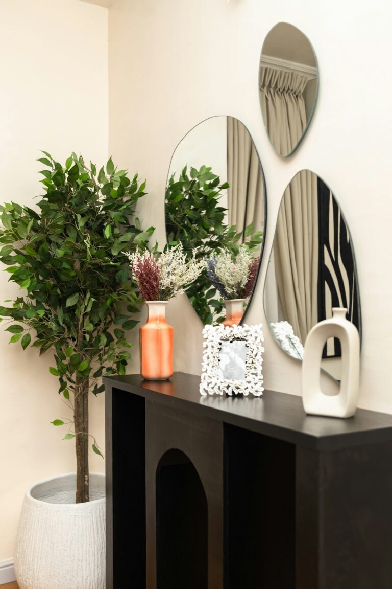 Styled entryway console with vases, stems and mirrors