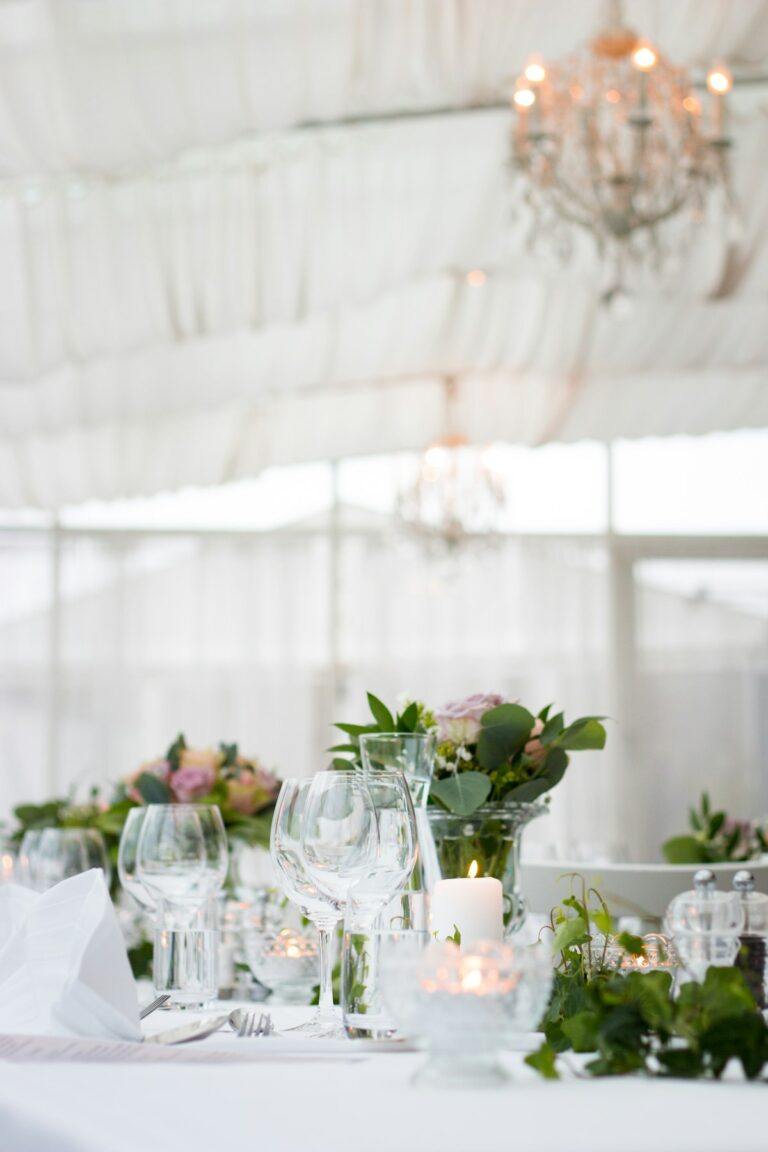 Wedding table styling with candles and glassware at golden hour